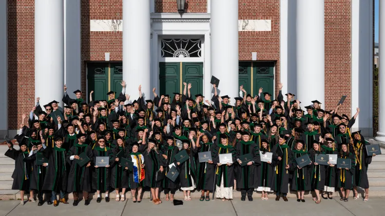 a large group of graduating medical students wearing academic regalia