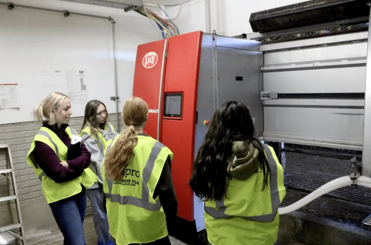 Student competitors assessing a milk tank in a dairy operation