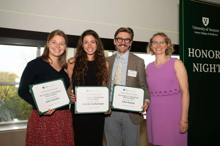 4 people with awards in hands smiling at the camera. 