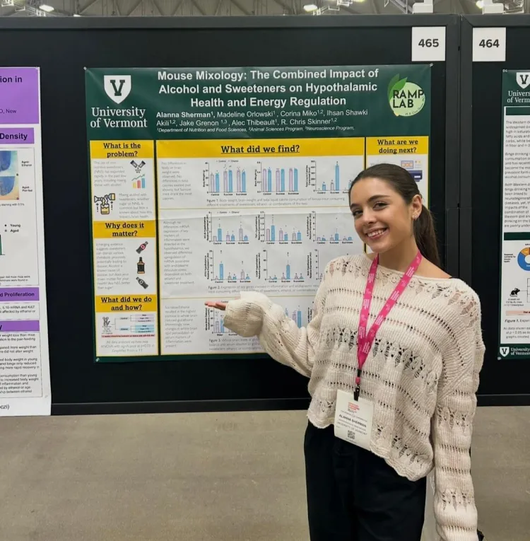 A woman in front of her research posterboard