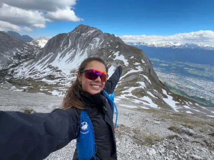 A woman in front of a mountain
