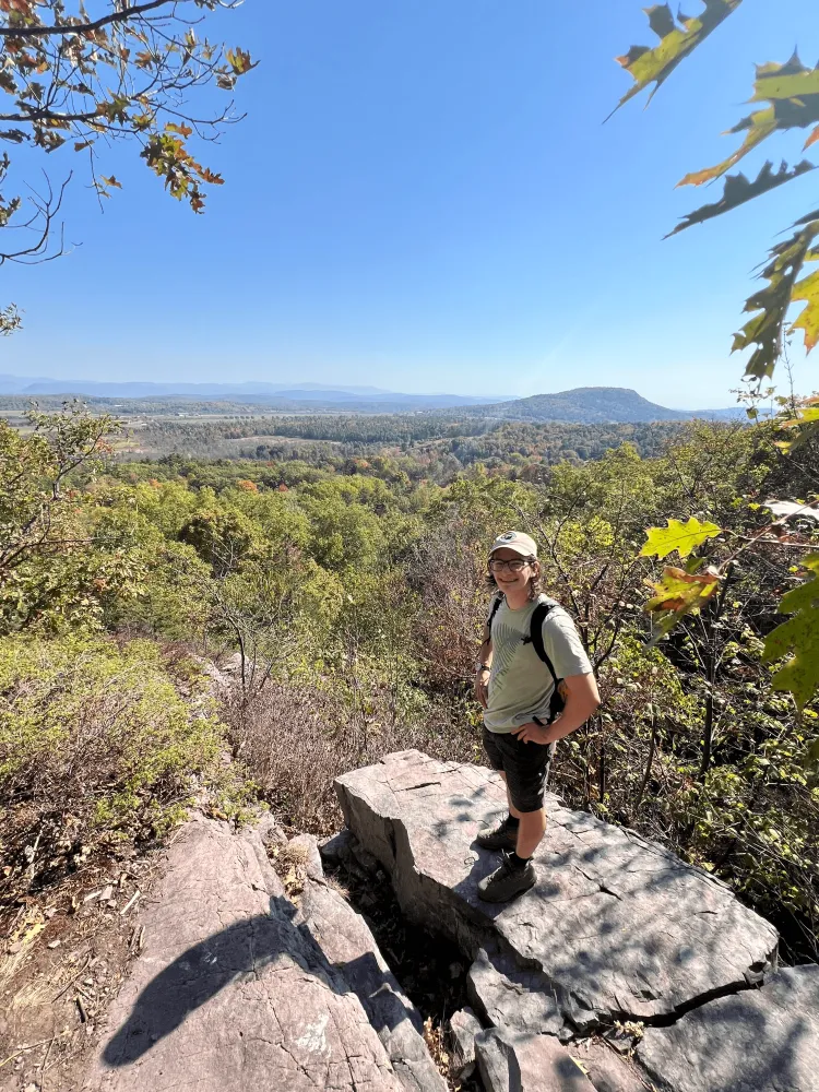 A man standing on top of a mountain vista