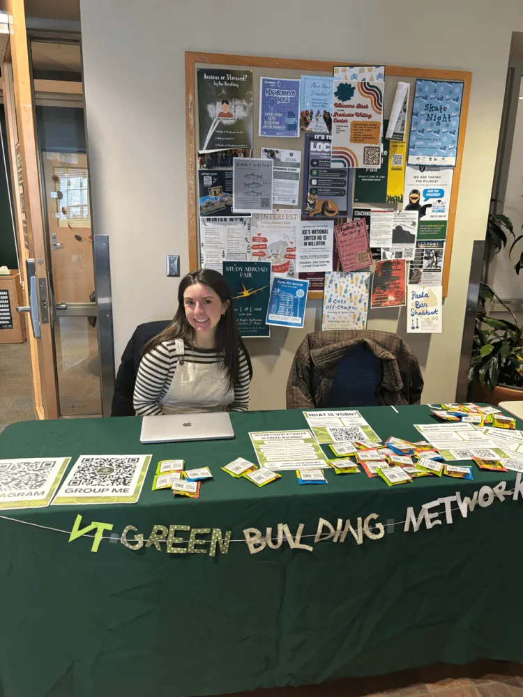 A woman manning a green building methods table