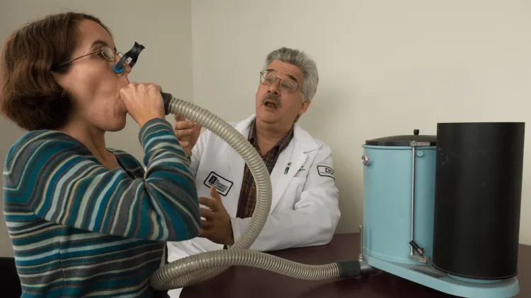 a doctor in a white coat with a patient breathing into a tube