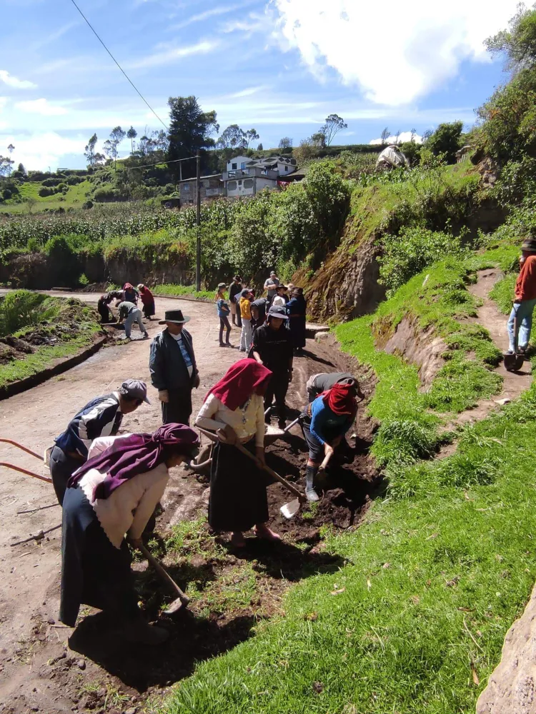 People work on a road on a hillside