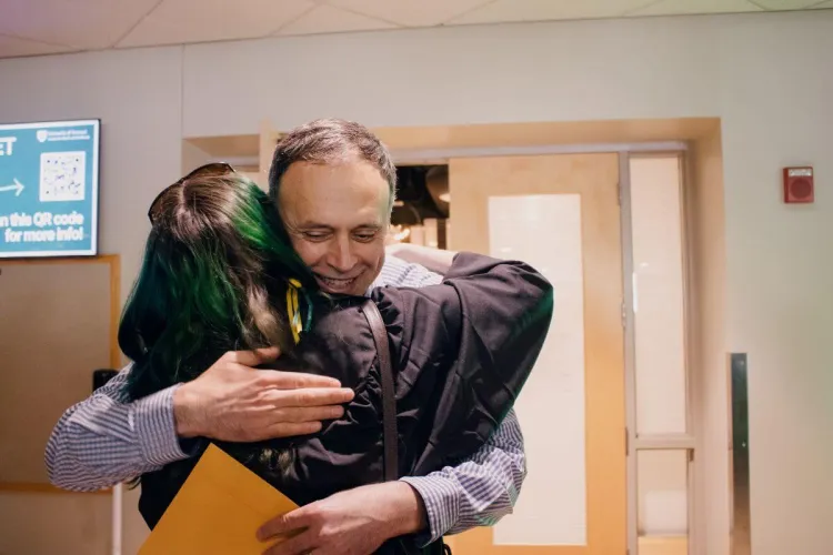 RSENR faculty member Luben Dimov hugging a student