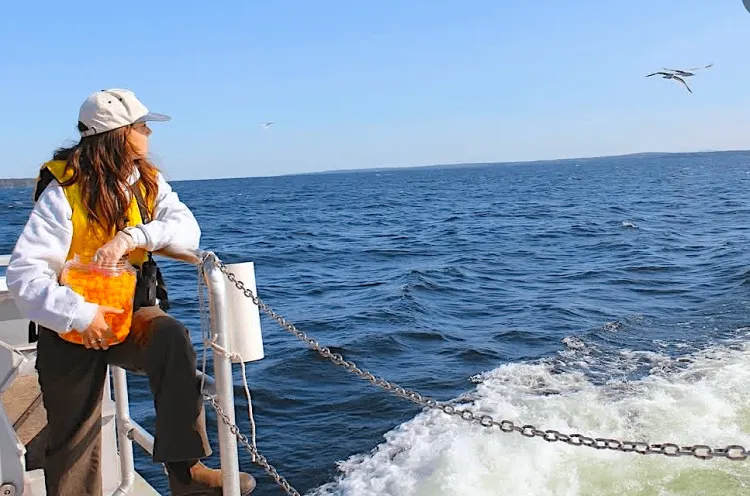 Woman on a boat with cheese puffs