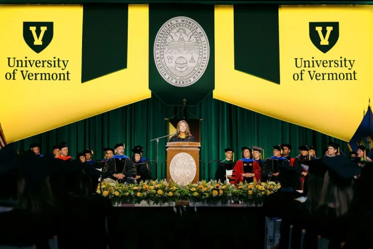 RSENR commencement speaker Heather Furman on the stage surrounded by faculty and graduates in regalia