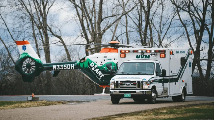 a UVM ambulance parked adjacent to an EMS helicopter