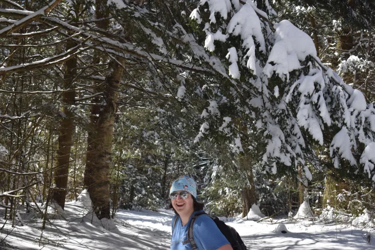 Carlos standing in a snowy forest.