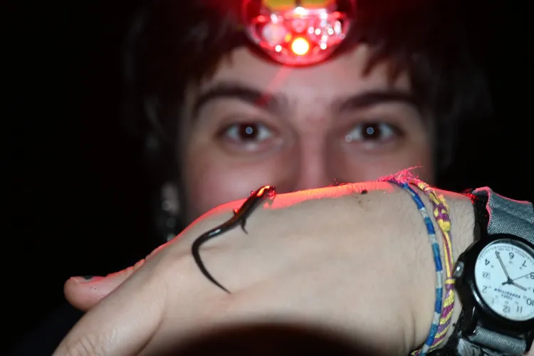 Carlos with a salamander on his hand.
