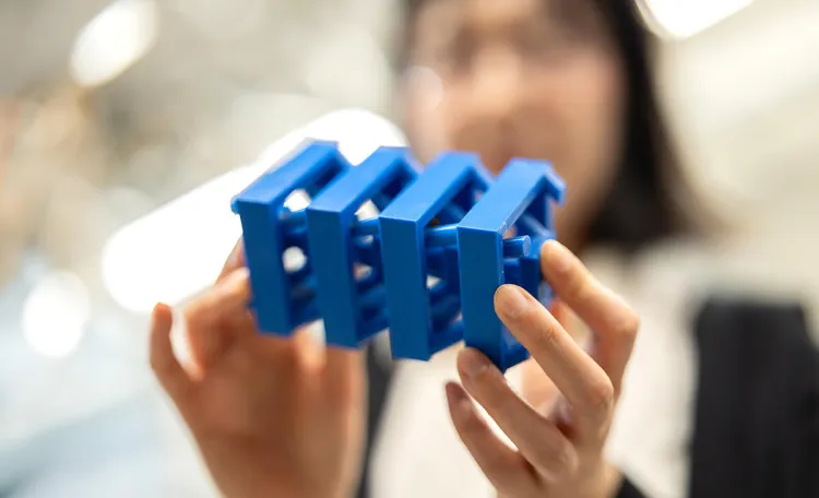 Professor Jihong Ma holds a 3D-printed metastructure designed in her lab