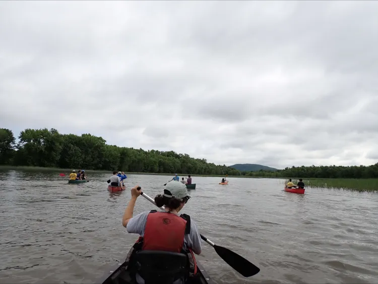 kayaks floating on a river.