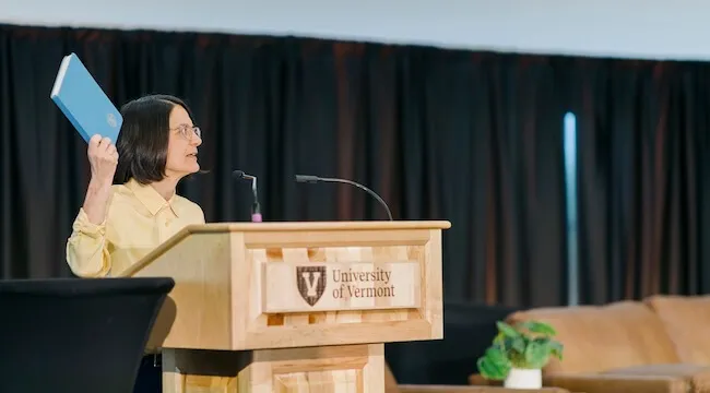 a woman speaks at a podium