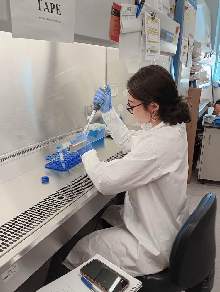 Woman working at a scientific bench pipetting