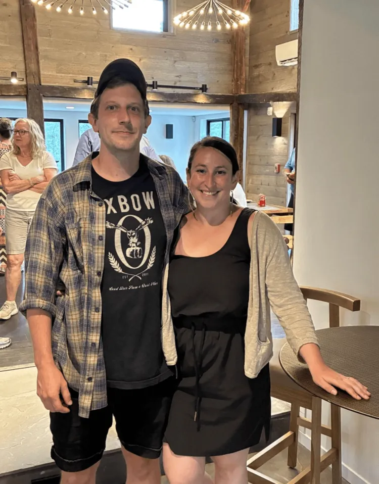 a young couple in a restaurant smiling