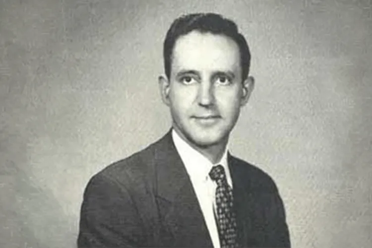 Person in suit smiling at the camera. 