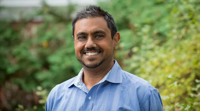 A portrait of Pablo Bose smiling 