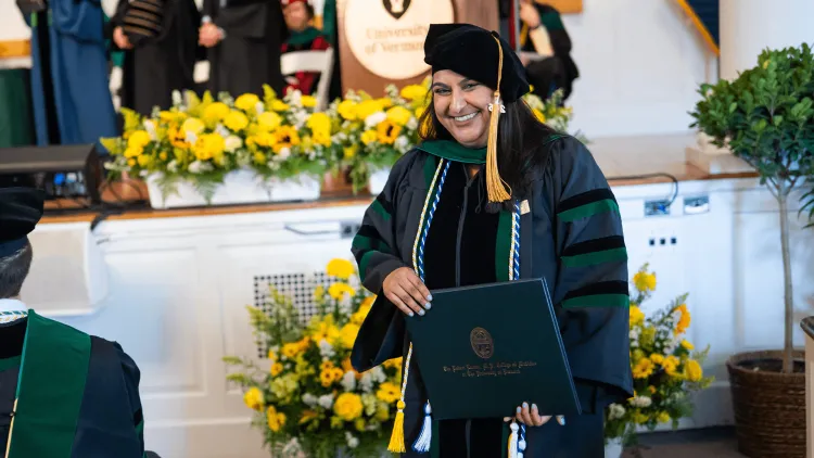 a person in academic regalia at a commencement ceremony