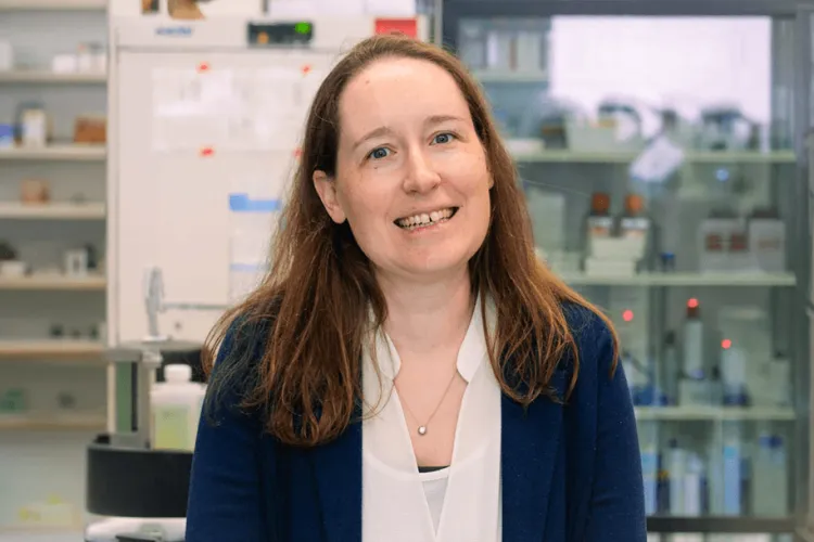 Person in a lab smiling at the camera. 