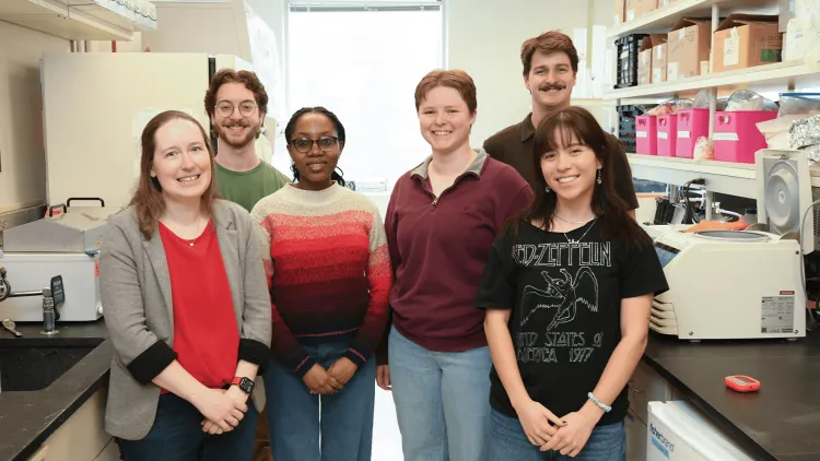 a group of people standing in a lab