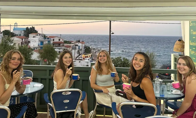 Students enjoy ice cream with view of the ocean in Ikaria, Greece