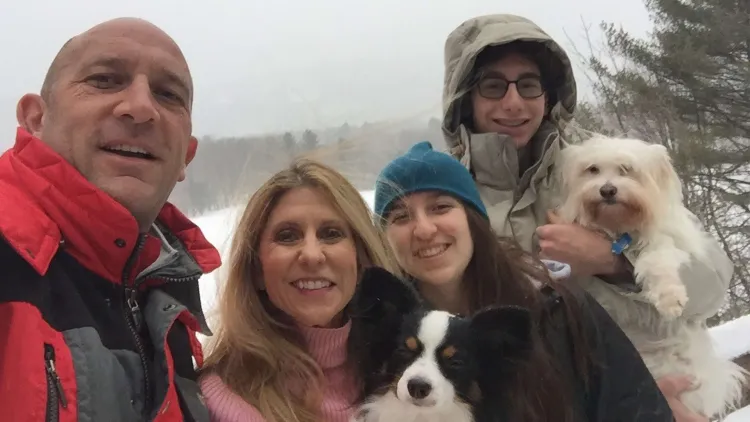 4 people and 2 dogs outside in winter