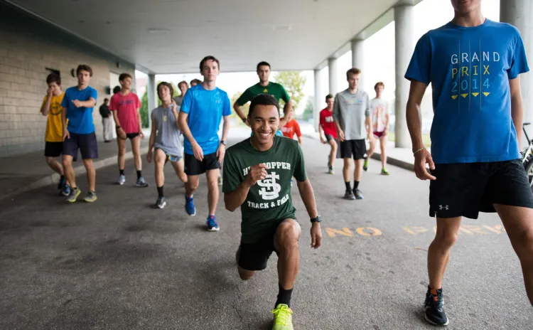 Students stretch outdoors near Patrick Gym