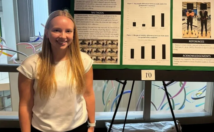 Shayenne Tomaski stands beside her research poster at the Zeigler Forum
