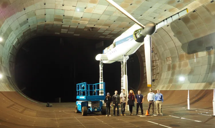 CEMS students pose for a group photo inside NASA's wind tunnel research facility