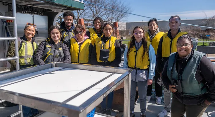Students pose for a group photo on a UVM research vessel