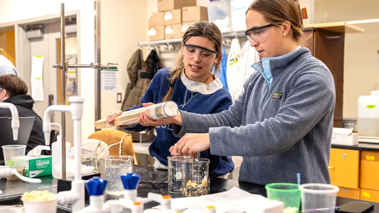 Two students collaborate on an experiment in a water research lab