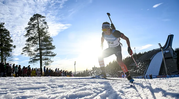 a biathlon skier in a race on a snowy course