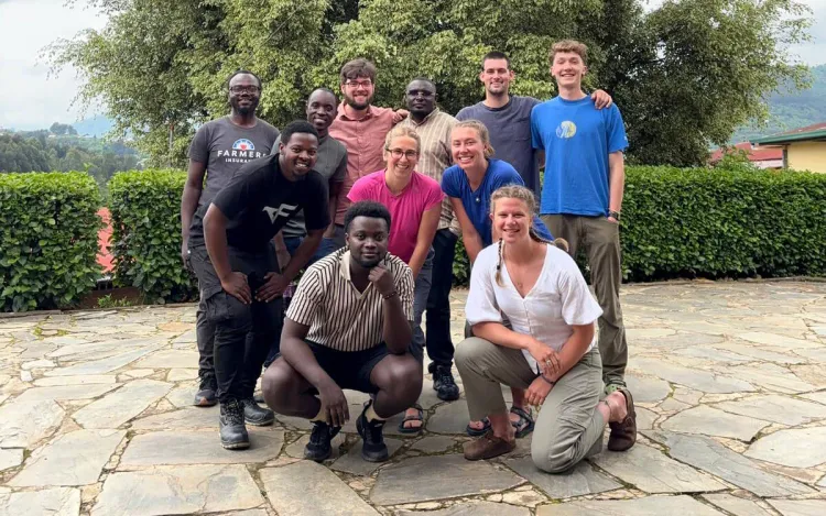 A group photo including student researchers and local residents in Rwanda