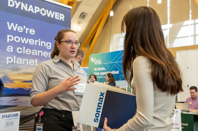 A prospective employer meets with a student at a STEM-focused career fair.