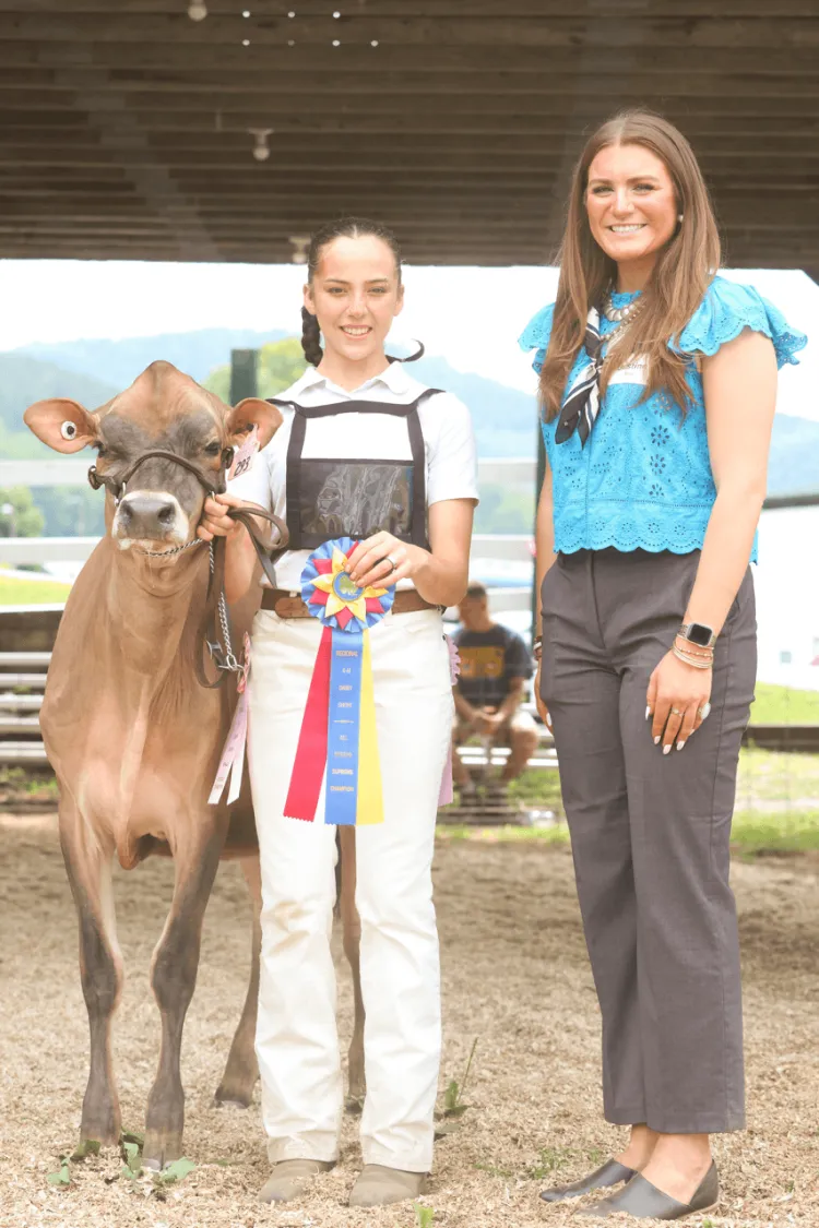 Grand Champion Winner with her calf and the 4-H dairy judge