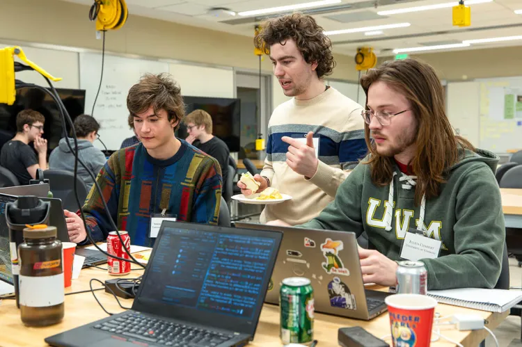Students working onm laptops at a classroom table