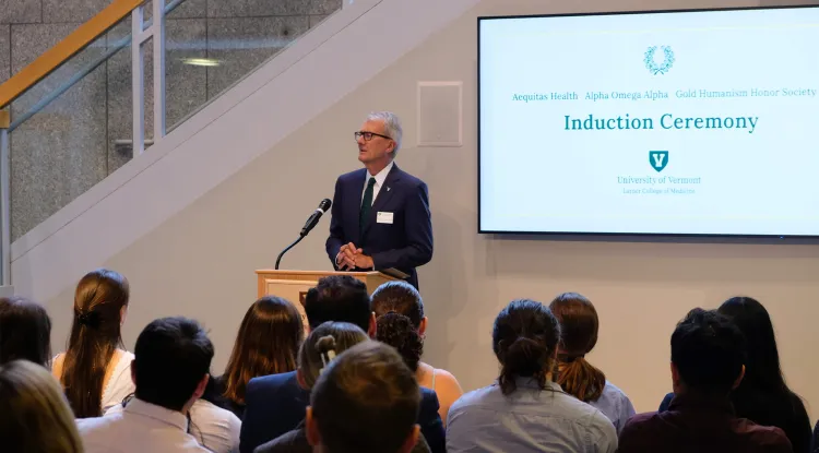 a person at a podium speaking to an audience