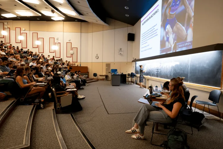 Faculty teaching hundreds of students in a large lecture hall
