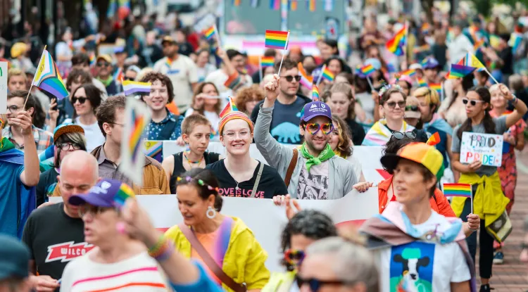 colorfully dressed people marching together in a parade