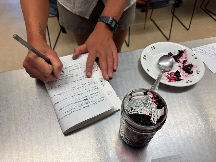 a jam tasters hands taking notes