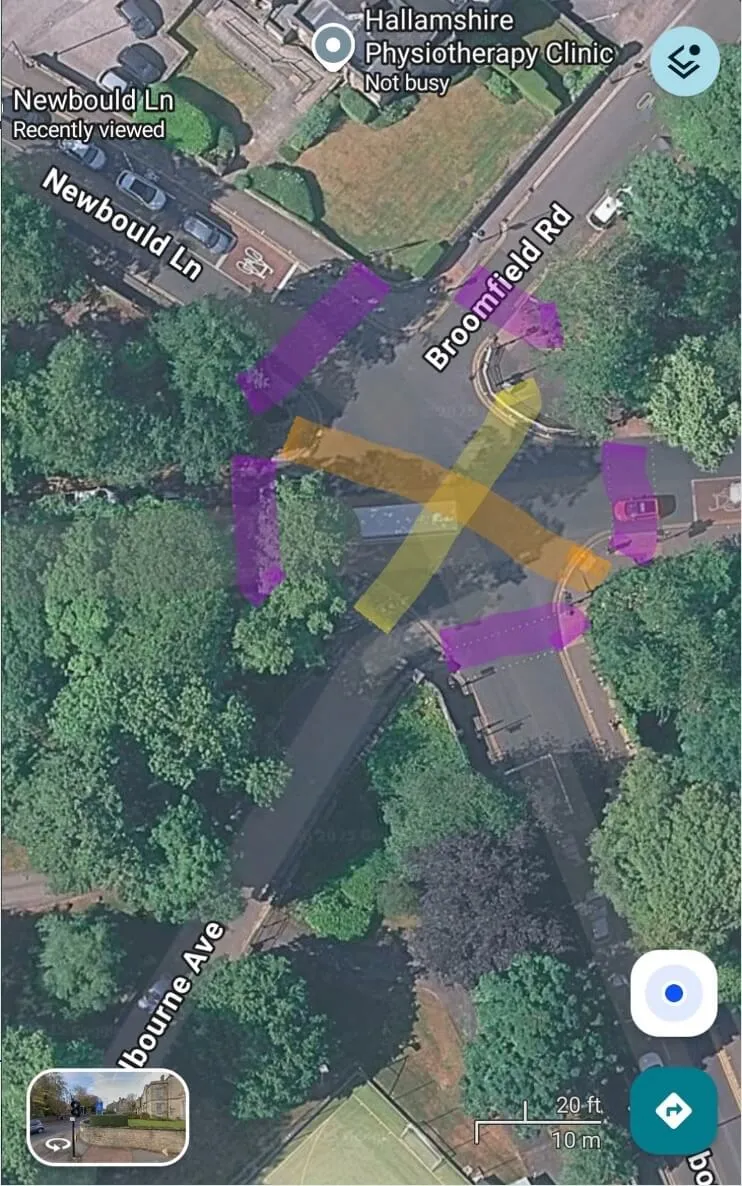Satellite view of a 5 way junction on street map, with the tree-lined route taken by some pedestrians marked out