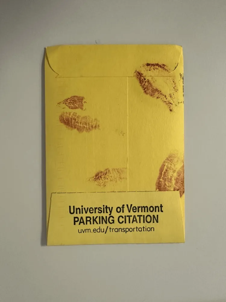A ticket payment envelope with lipstick on it