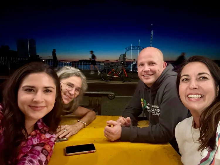 Four people pose at a table