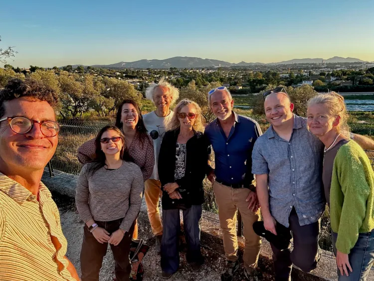 Group of people take a photo in front of mountain range
