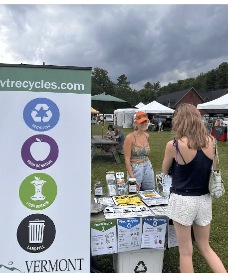 Alessia Grant Noble stands at an information booth