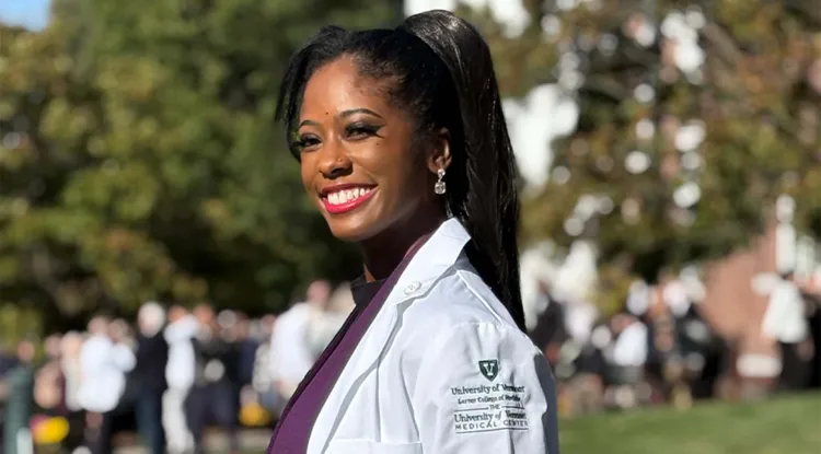 a person in a white coat standing outdoors