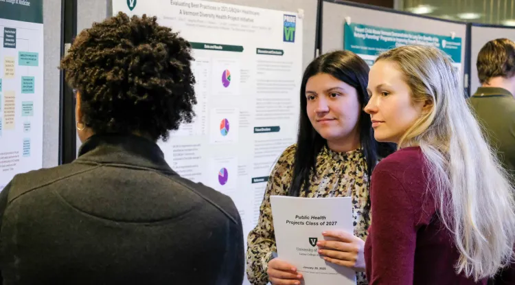 3 people at an academic poster session