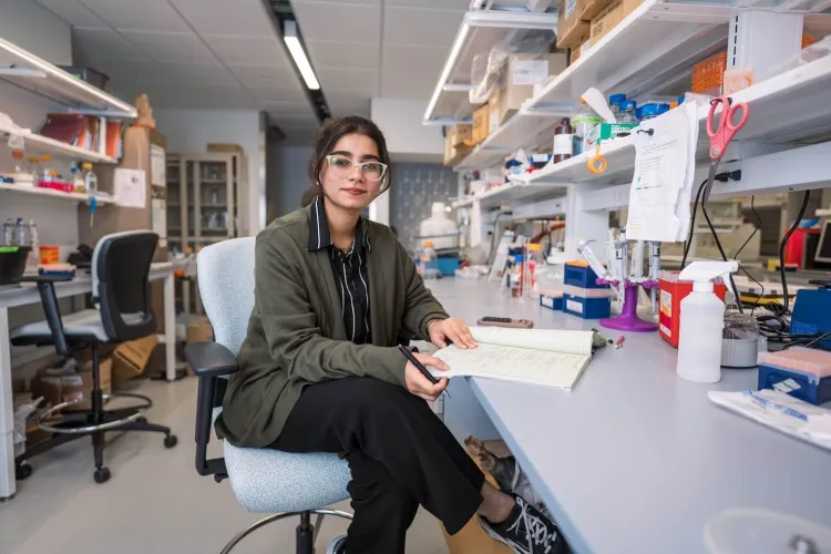 woman with notebook in lab