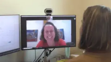 Two people in an online meeting